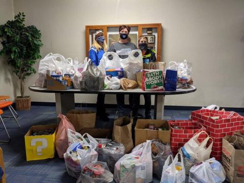 Mrs. Boyce, Mrs. Hanley and JD Hanley showcase the food collected at the drive-by food drive. 