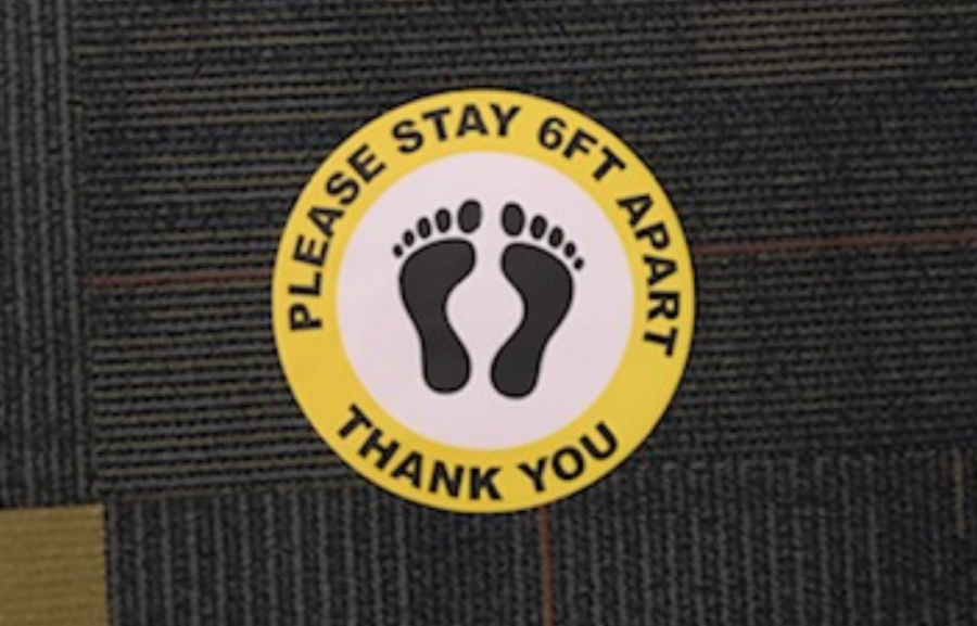 A sticker reminds students to stay socially distant. 